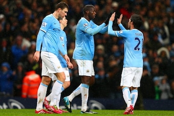 MANCHESTER, ENGLAND - JANUARY 08:  Yaya Toure of Manchester City celebrates scoring their third goal with David Silva of Manchester City during the Capital One Cup Semi-Final first leg match between Manchester City and West Ham United at Etihad Stadium on