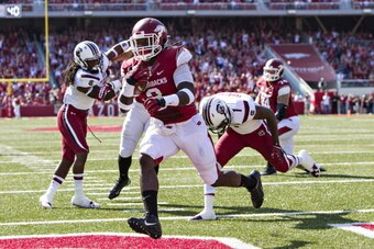 FAYETTEVILLE, AR - OCTOBER 12: Alex Collins #3 of the Arkansas Razorbacks rushes for a touchdown against the South Carolina Gamecocks at Razorback Stadium on October 12, 2013 in Fayetteville, Arkansas. The Gamecocks defeated the Razorbacks 52-7. (Photo by