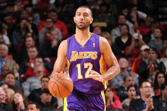 HOUSTON, TX - JANUARY 8:  Kendall Marshall #12 of the Los Angeles Lakers drives against the Houston Rockets on January 8, 2014 at the Toyota Center in Houston, Texas. NOTE TO USER: User expressly acknowledges and agrees that, by downloading and or using t