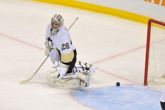BOSTON, MA - NOVEMBER 25: Marc-Andre Fleury #29 of the Pittsburgh Penguins misses the puck to loose in overtime against the Boston Bruins at the TD Garden on November 25, 2013 in Boston, Massachusetts.  (Photo by Steve Babineau/NHLI via Getty Images)