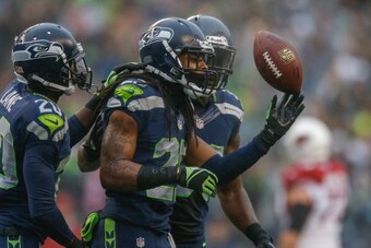 SEATTLE, WA - DECEMBER 22:  Cornerback Richard Sherman #25 of the Seattle Seahawks celebrates with teammates after making an interception against the Arizona Cardinals at CenturyLink Field on December 22, 2013 in Seattle, Washington.  (Photo by Otto Greul