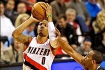 Jan 8, 2014; Portland, OR, USA; Portland Trail Blazers point guard Damian Lillard (0) shoots over Orlando Magic shooting guard Arron Afflalo (4) at the Moda Center. Mandatory Credit: Craig Mitchelldyer-USA TODAY Sports