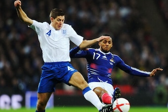 LONDON, ENGLAND - NOVEMBER 17:  Andy Carroll of England battles with Yann M'Vila of France during the international friendly match between England and France at Wembley Stadium on November 17, 2010 in London, England.  (Photo by Mike Hewitt/Getty Images)