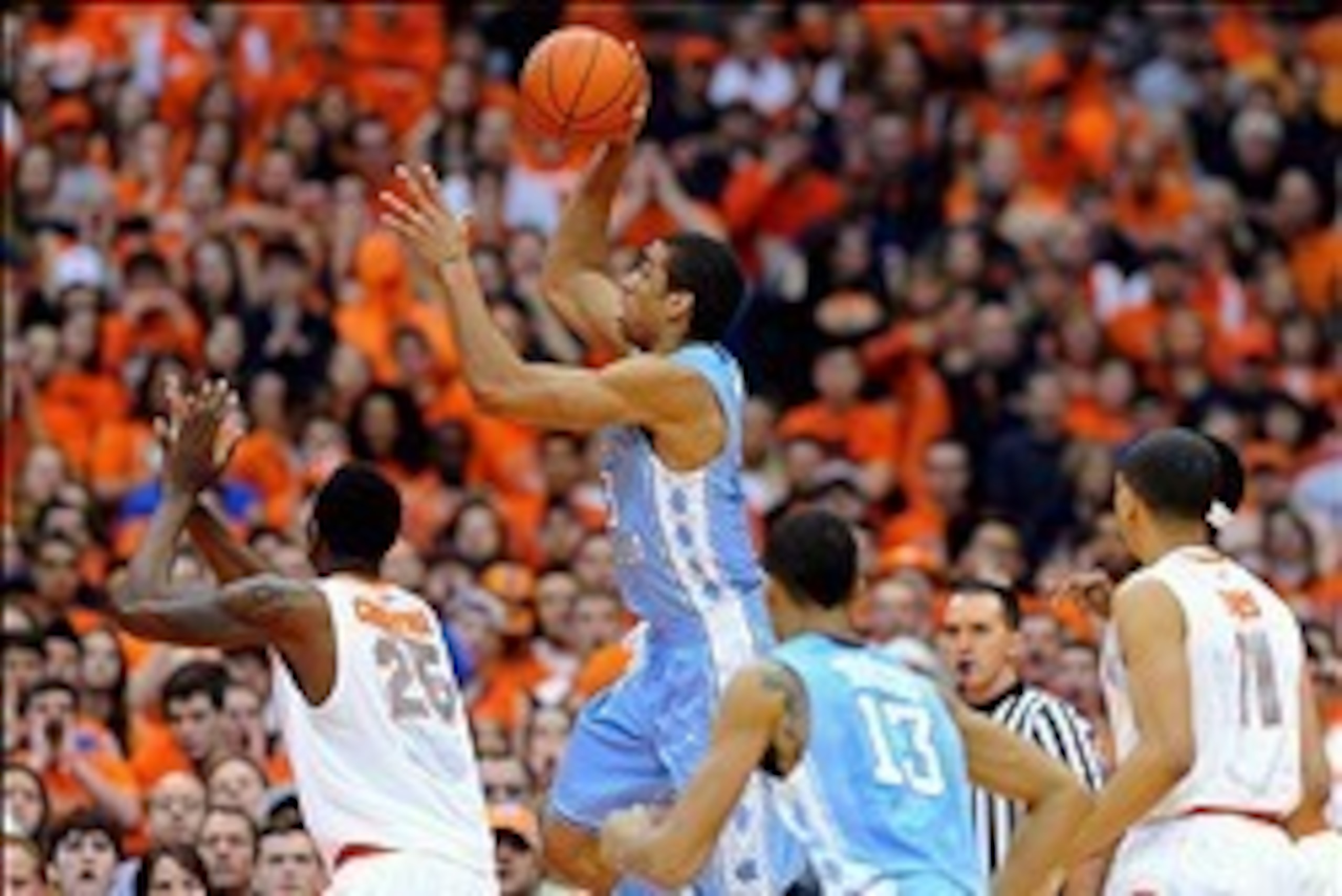 Jan 11, 2014; Syracuse, NY, USA; North Carolina Tar Heels forward James Michael McAdoo (43) takes a shot over Syracuse Orange forward Rakeem Christmas (25) during the first half at the Carrier Dome.  Mandatory Credit: Rich Barnes-USA TODAY Sports