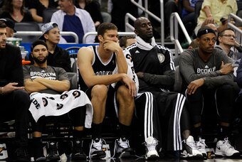 Nov 3, 2013; Orlando, FL, USA; Brooklyn Nets point guard Deron Williams (8), center Brook Lopez (11), power forward Kevin Garnett (2) and small forward Paul Pierce (34) react on the bench against the Orlando Magic during the second half at Amway Center. O