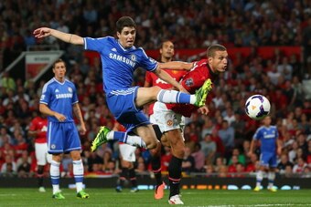 MANCHESTER, ENGLAND - AUGUST 26:  Oscar of Chelsea is challenged by Nemanja Vidic of Manchester United  during the Barclays Premier League match between Manchester United and Chelsea at Old Trafford on August 26, 2013 in Manchester, England.  (Photo by Al