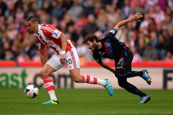 STOKE ON TRENT, ENGLAND - AUGUST 24:  Geoff Cameron of Stoke battles with Jose Campana of Palace during the Barclays Premier League match between Stoke City and Crystal Palace at Britannia Stadium on August 24, 2013 in Stoke on Trent, England.  (Photo by 