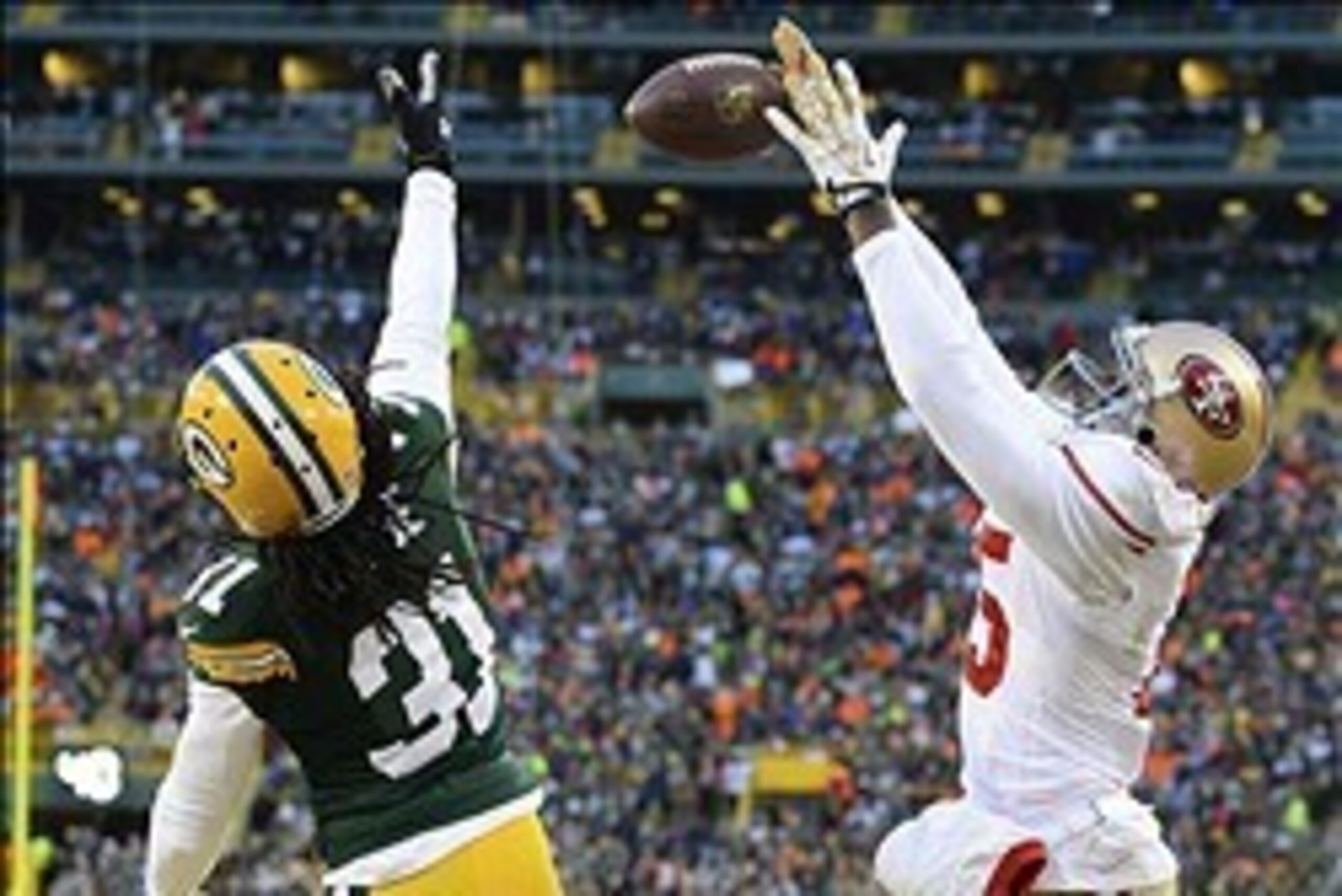 Jan 5, 2014; Green Bay, WI, USA; San Francisco 49ers wide receiver Michael Crabtree (15) attempts to make a catch as Green Bay Packers cornerback Davon House (31) defends during the first quarter of the 2013 NFC wild card playoff football game at Lambeau Jan 5, 2014; Green Bay, WI, USA; San Francisco 49ers wide receiver Michael Crabtree (15) attempts to make a catch as Green Bay Packers cornerback Davon House (31) defends during the first quarter of the 2013 NFC wild card playoff football game at Lambeau