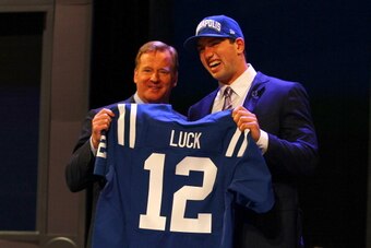 NEW YORK, NY - APRIL 26:  Andrew Luck (R) from Stanford holds up a jersey as he stands on stage with NFL Commissioner Roger Goodell after Luck was selected #1 overall by the Indianapolis Colts in the first round of the 2012 NFL Draft at Radio City Music H