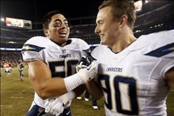 Dec 12, 2013; Denver, CO, USA; San Diego Chargers linebackers Manti Te'o and Thomas Keiser (90) celebrate after the game against the Denver Broncos at Sports Authority Field at Mile High. The Chargers won 27-20.  Mandatory Credit: Chris Humphreys-USA TODA