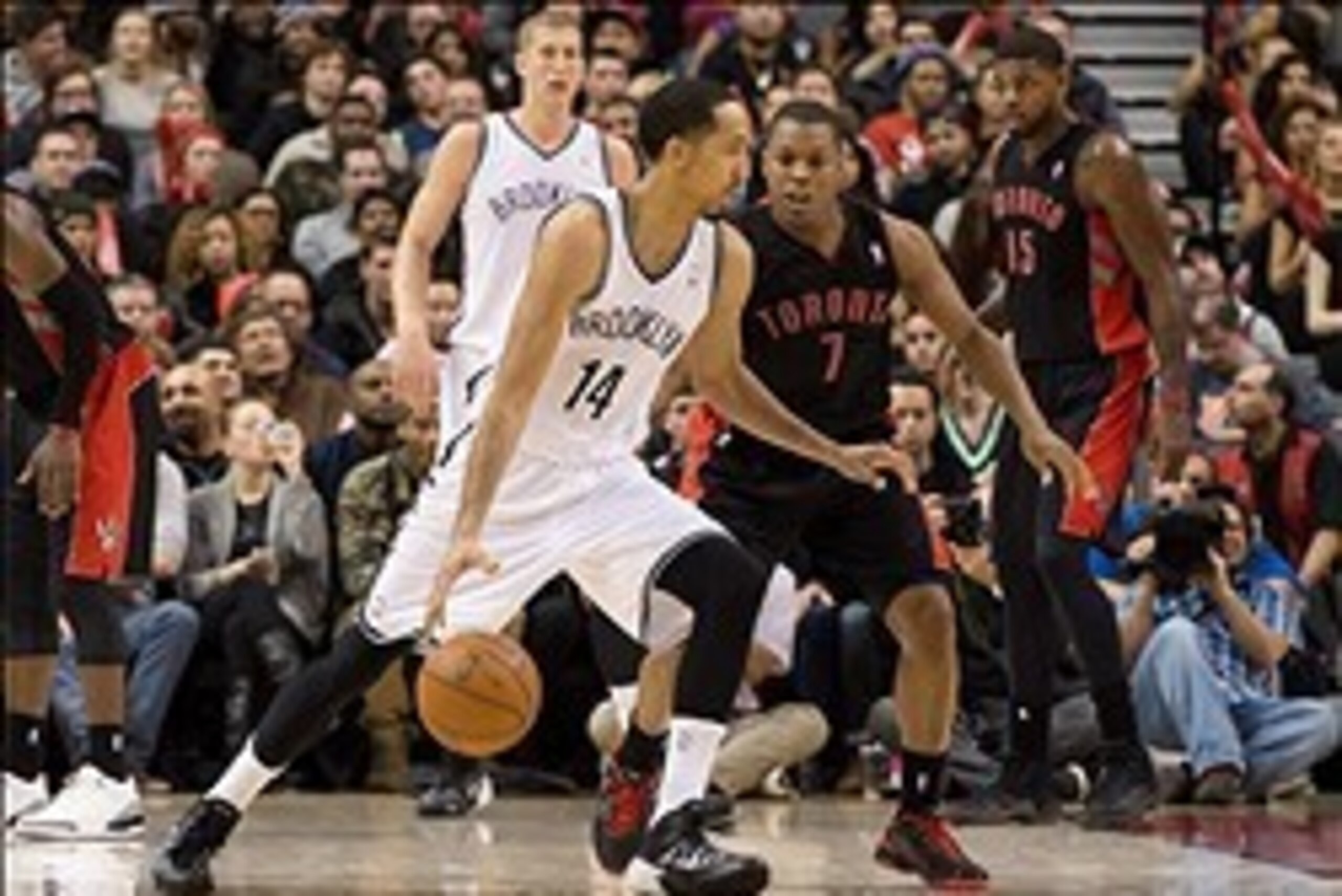 Jan 11, 2014; Toronto, Ontario, CAN; Brooklyn Nets point guard Shaun Livingston (14) battles with Toronto Raptors point guard Kyle Lowry (7) during the 4th quarter in a game at the Air Canada Centre.  The Toronto Raptors won 96-80. Mandatory Credit: Nick 