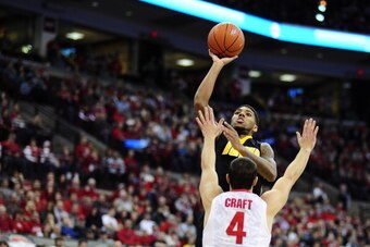 COLUMBUS, OH - JANUARY 12:  Roy Devyn Marble #4 of the Iowa Hawkeyes goes for a lay up over Aaron Craft #4 of the Ohio State Buckeyes on January 12, 2014 at Value City Arena in Columbus, Ohio.   (Photo by Ryan Young/Getty Images)