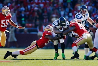 SAN FRANCISCO, CA - DECEMBER 08:  Running back Marshawn Lynch #24 of the Seattle Seahawks gets caught by linebackers Patrick Willis #52 and NaVorro Bowman #53 of the San Francisco 49ers after a gain of six yards early in the first quarter on December 8, 2
