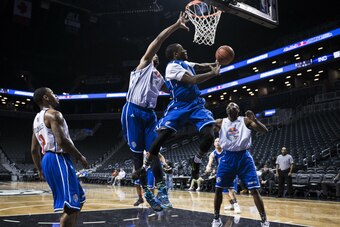 Nelson (blue) swoops to the tin with Williams (white) contesting the shot. Nelson (blue) swoops to the tin with Williams (white) contesting the shot.