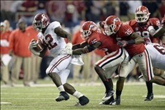 Dec 1, 2012; Atlanta, GA, USA; Alabama Crimson Tide running back Eddie Lacy (42) is brought down by Georgia Bulldogs safety Shawn Williams (36) during the third quarter of the 2012 SEC Championship game at the Georgia Dome.  Mandatory Credit: Paul Abell-U