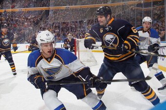BUFFALO, NY - NOVEMBER 19:  Mike Weber #6 of the Buffalo Sabres battles along the boards against Vladimir Sobotka #17 of the St. Louis Blues on November 19, 2013 at the First Niagara Center in Buffalo, New York.  (Photo by Bill Wippert/NHLI via Getty Imag