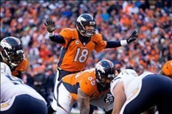 Jan 12, 2014; Denver, CO, USA; Denver Broncos quarterback Peyton Manning (18) calls a play in the second quarter against the San Diego Chargers during the 2013 AFC divisional playoff football game at Sports Authority Field at Mile High. Mandatory Credit: 
