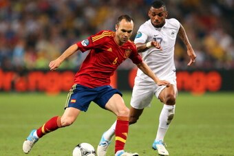 DONETSK, UKRAINE - JUNE 23: Andres Iniesta of Spain and Yann M'Vila of France in action during the UEFA EURO 2012 quarter final match between Spain and France at Donbass Arena on June 23, 2012 in Donetsk, Ukraine.  (Photo by Alex Livesey/Getty Images)