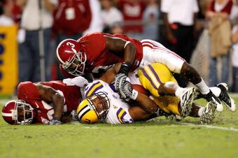 TUSCALOOSA, AL - NOVEMBER 07:  Trent Richardson #3 and Javier Arenas #28 of the Alabama Crimson Tide tackle Charles Scott #32 of the Louisiana State University Tigers at Bryant-Denny Stadium on November 7, 2009 in Tuscaloosa, Alabama.  (Photo by Kevin C. 