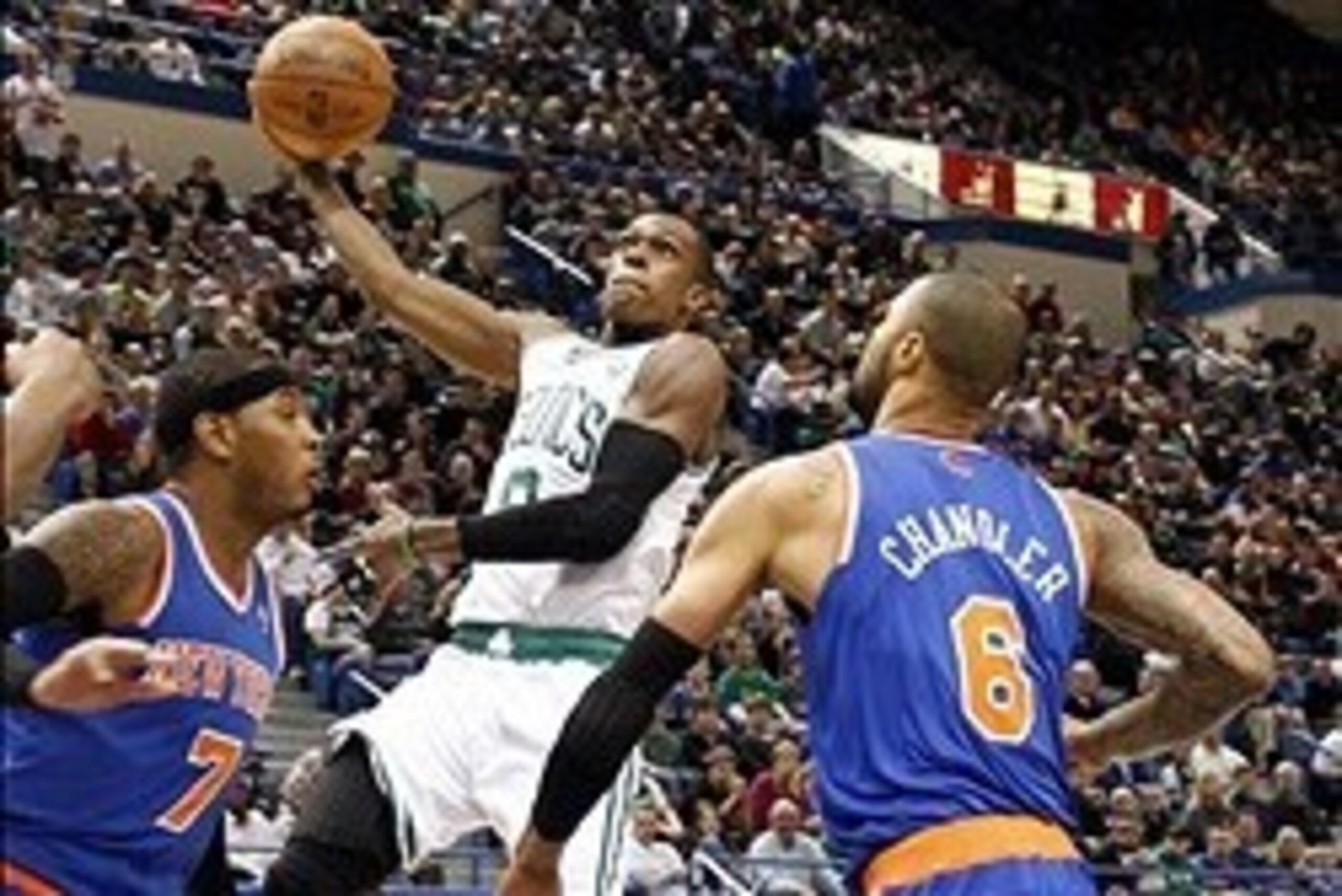 Oct 13, 2012; Hartford, CT, USA; Boston Celtics guard Rajon Rondo (9) shoots the ball against New York Knicks forward Carmelo Anthony (7) and center Tyson Chandler (6) during the first half at XL Center.  Mandatory Credit: Mark L. Baer-USA TODAY Sports