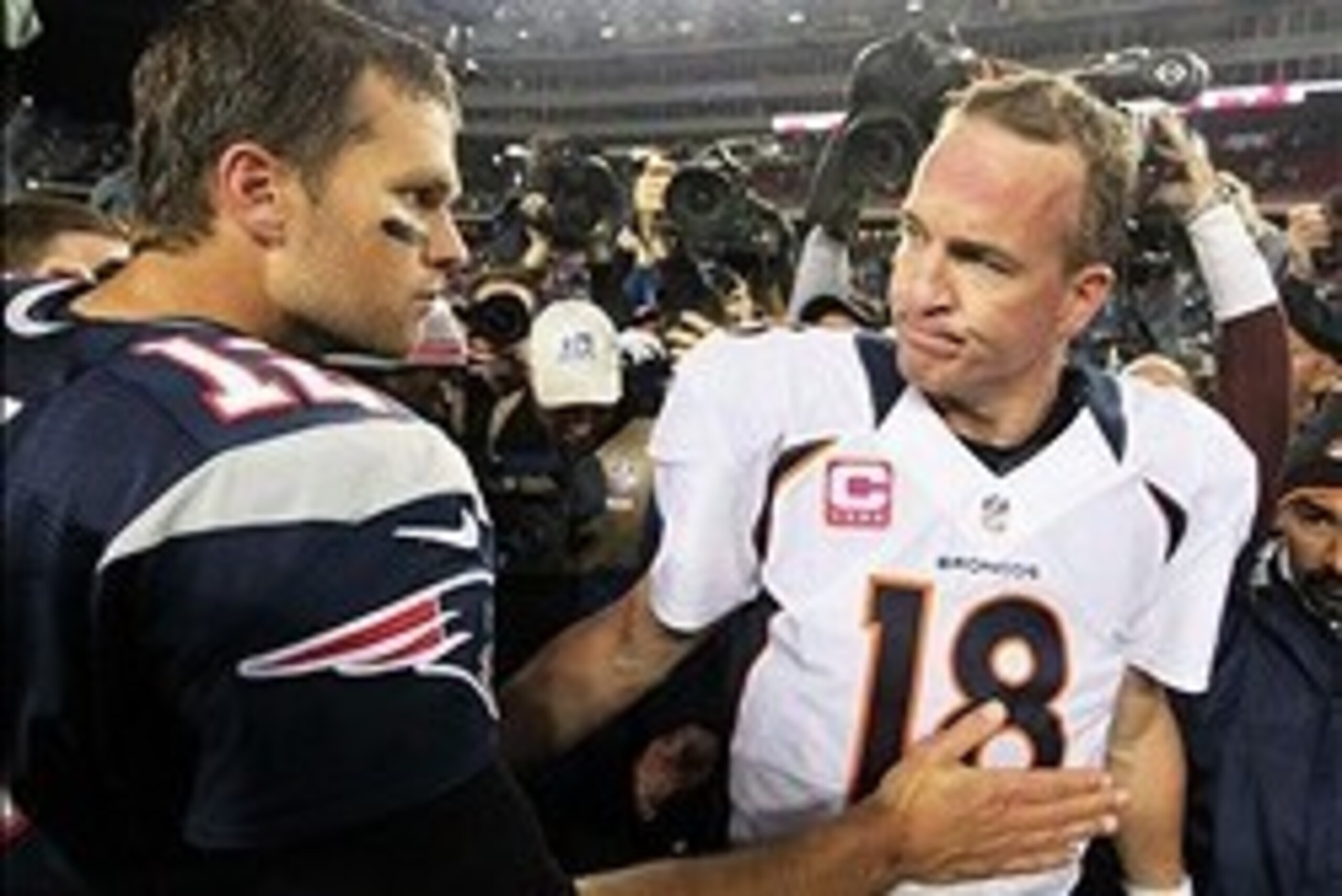 Oct 7, 2012; Foxborough, MA, USA; New England Patriots quarterback Tom Brady (12) shakes hands with Denver Broncos quarterback Peyton Manning (18) following the game at Gillette Stadium. The Patriots defeated the Broncos 31-21. Mandatory Credit: Stew Miln