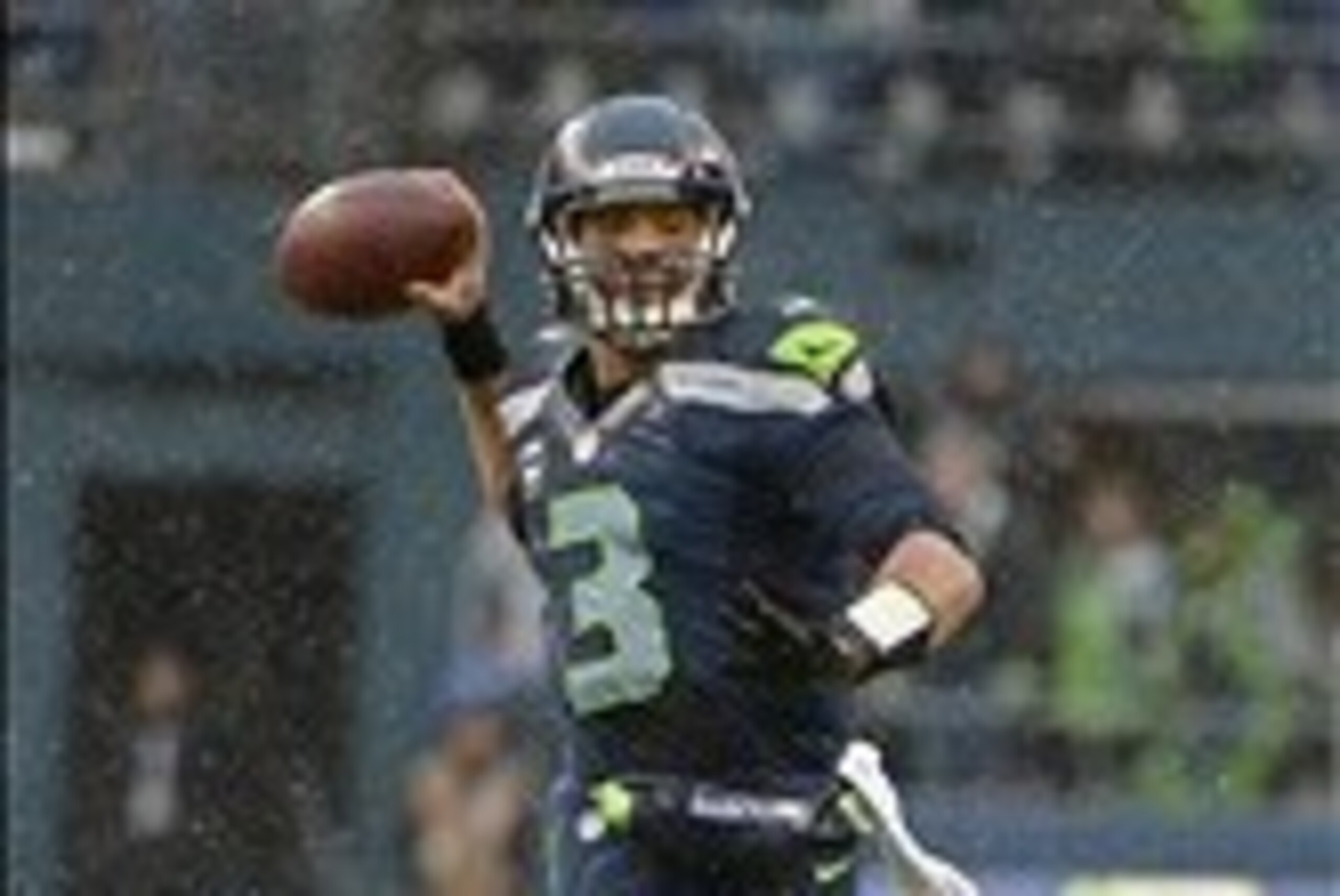 Jan 11, 2014; Seattle, WA, USA; Seattle Seahawks quarterback Russell Wilson (3) passes the ball against the New Orleans Saints during the first half of the 2013 NFC divisional playoff football game at CenturyLink Field. Mandatory Credit: Kirby Lee-USA TOD