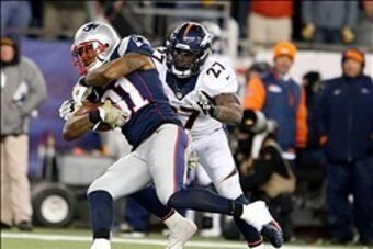 Nov 24, 2013; Foxborough, MA, USA; New England Patriots cornerback Aqib Talib (31) intercepts a pass intended for Denver Broncos running back Knowshon Moreno (27) in the fourth quarter at Gillette Stadium. The New England Patriots defeated the Denver Bron