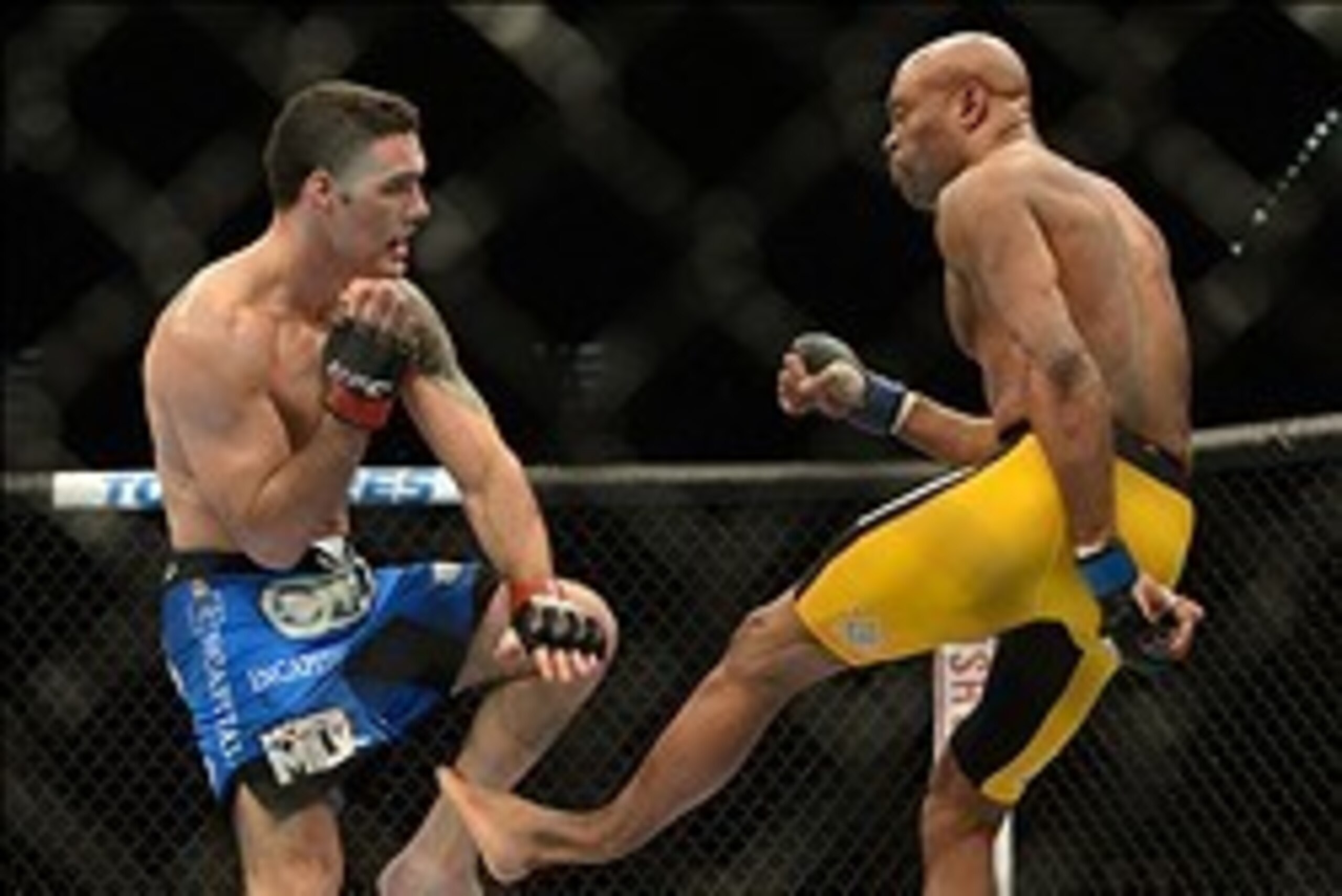 Dec 28, 2013; Las Vegas, NV, USA;   (EDITORS NOTE: graphic content) Anderson Silva (blue gloves) breaks his leg on a kick to Chris Weidman (red gloves) during their UFC middleweight championship bout at the MGM Grand Garden Arena. Mandatory Credit: Jayne 