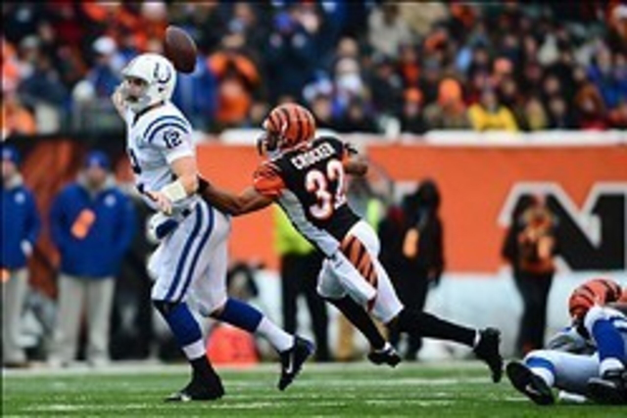 Dec 8, 2013; Cincinnati, OH, USA; Indianapolis Colts quarterback Andrew Luck (12) throws a pass while being pressed by Cincinnati Bengals defensive back Chris Crocker (32) during the second quarter at Paul Brown Stadium. Mandatory Credit: Andrew Weber-USA