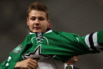 NEWARK, NJ - JUNE 30:  Valeri Nichushkin puts on his jersey after being selected tenth overall by the Dallas Stars during the 2013 NHL Draft at Prudential Center on June 30, 2013 in Newark, New Jersey.  (Photo by Dave Sandford/NHLI via Getty Images)