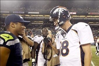 Aug 17, 2013; Seattle, WA, USA; Seattle Seahawks quarterback Russell Wilson (3) and Denver Broncos quarterback Peyton Manning (18) speak following a 40-10 preseason victory by the Seahawks at CenturyLink Field. Mandatory Credit: Joe Nicholson-USA TODAY Sp