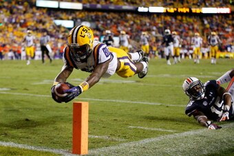 BATON ROUGE, LA - SEPTEMBER 21:  Jarvis Landry #80 of the LSU Tigers dives for a touchdown after avoiding a tackle by Joshua Holsey #15 of the Auburn Tigers at Tiger Stadium on September 21, 2013 in Baton Rouge, Louisiana.  (Photo by Chris Graythen/Getty 