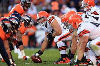 DENVER, CO - DECEMBER 23:  Center Alex Mack #55 of the Cleveland Browns prepares to snap the ball to quarterback Brandon Weeden #3 of the Cleveland Browns against the Denver Broncos at Sports Authority Field at Mile High on December 23, 2012 in Denver, Co