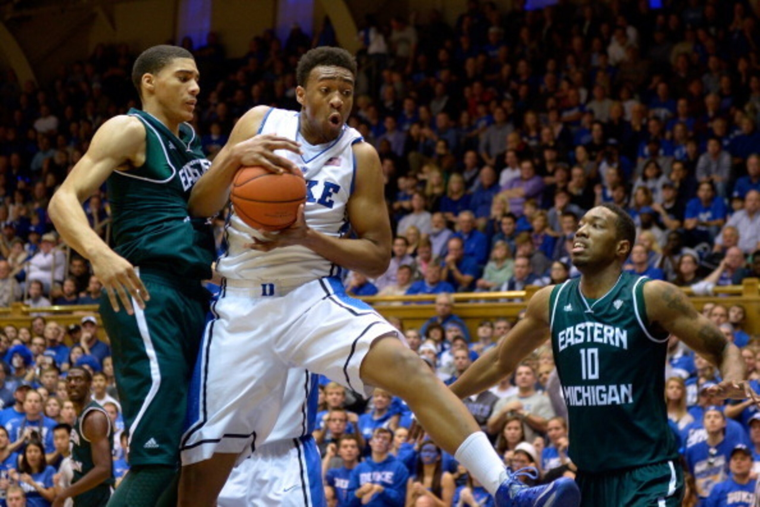 DURHAM, NC - DECEMBER 28:  Jabari Parker #1 of the Duke Blue Devils pulls down a rebound against Karrington Ward #14 and Da'Shonte Riley #10 of the Eastern Michigan Eagles during their game at Cameron Indoor Stadium on December 28, 2013 in Durham, North C