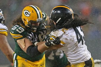 GREEN BAY, WI - DECEMBER 22:  David Bakhtiari #69 of the Green Bay Packers blocks Troy Polamalu #43 of the Pittsburgh Steelers at Lambeau Field on December 22, 2013 in Green Bay, Wisconsin.  The Steelers defeated the Packers 38-31.  (Photo by Jonathan Dan