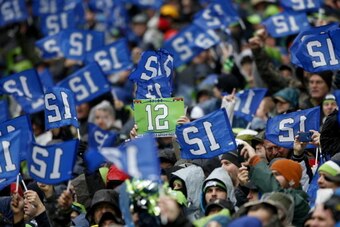 SEATTLE, WA - JANUARY 11:  Seattle Seahawks fans hold up 12th Man signs as the Seahawks take on the New Orleans Saints during the NFC Divisional Playoff Game at CenturyLink Field on January 11, 2014 in Seattle, Washington.  (Photo by Otto Greule Jr/Getty 