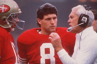 NOV 1987:  SAN FRANCISCO QUARTERBACK JOE MONTANA TALKS WITH HEAD COACH BILL WALSH, AS BACKUP QUARTERBACK STEVE YOUNG LISTENS, DURING THE 49ERS GAME AT CANDLESTICK PARK IN SAN FRANCISCO, CALIFORNIA. Mandatory Credit: Otto Greule/ALLSPORT