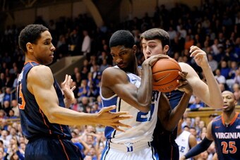 DURHAM, NC - JANUARY 13:  Malcolm Brogdon #15 and Joe Harris #12 of the Virginia Cavaliers battle for a rebound with Amile Jefferson #21 of the Duke Blue Devils during a game at Cameron Indoor Stadium on January 13, 2014 in Durham, North Carolina.  (Photo