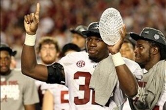 Jan 7, 2013; Miami, FL, USA; Alabama Crimson Tide linebacker C.J. Mosley (32) celebrates with the Coaches Trophy after the 2013 BCS Championship game against the Notre Dame Fighting Irish at Sun Life Stadium. Alabama won 42-14.  Mandatory Credit: Matthew