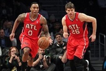 Jan 6, 2014; Brooklyn, NY, USA; Atlanta Hawks point guard Jeff Teague (0) and shooting guard Kyle Korver (26) bring the ball up court against the Brooklyn Nets during the first quarter of a game at Barclays Center. The Nets defeated the Hawks 91-86. Manda