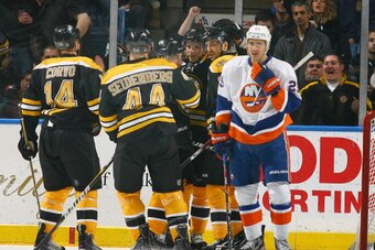 UNIONDALE, NY - NOVEMBER 19: The Boston Bruins celebrate a goal as Nino Niederreiter #25 of the New York Islanders looks away during their game at the Nassau Coliseum on November 19, 2011 in Uniondale, New York. (Photo by Andy Marlin/NHLI via Getty Images