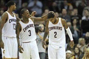 Nov 9, 2013; Cleveland, OH, USA; Cleveland Cavaliers point guard Kyrie Irving (2) is consoled by power forward Tristan Thompson (13) and shooting guard Dion Waiters (3) after missing a shot at the end of regulation against the Philadelphia 76ers at Quicke