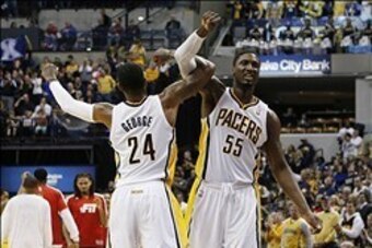 Jan 10, 2014; Indianapolis, IN, USA; Indiana Pacers forward Paul George (24) celebrates with center Roy Hibbert (55) after the Pacers scored against the Washington Wizards at Bankers Life Fieldhouse. Indiana defeats Washington 93-66. Mandatory Credit: Bri