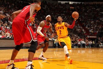 MIAMI, FL - FEBRUARY 24:  Kyrie Irving #2 of the Cleveland Cavaliers drives against LeBron James #6 of the Miami Heat  during a game between the Cleveland Cavaliers and the Miami Heat on February 24, 2013 at American Airlines Arena in Miami, Florida. NOTE