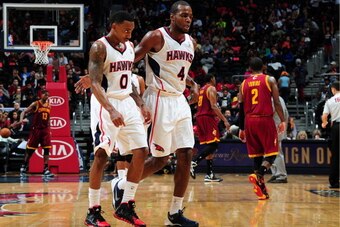 ATLANTA, GA - DECEMBER 6:  Jeff Teague #0 and Paul Millsap #4 of the Atlanta Hawks walk off the court during the game against the Cleveland Cavaliers on December 6, 2013 at Philips Arena in Atlanta, Georgia.  NOTE TO USER: User expressly acknowledges and 