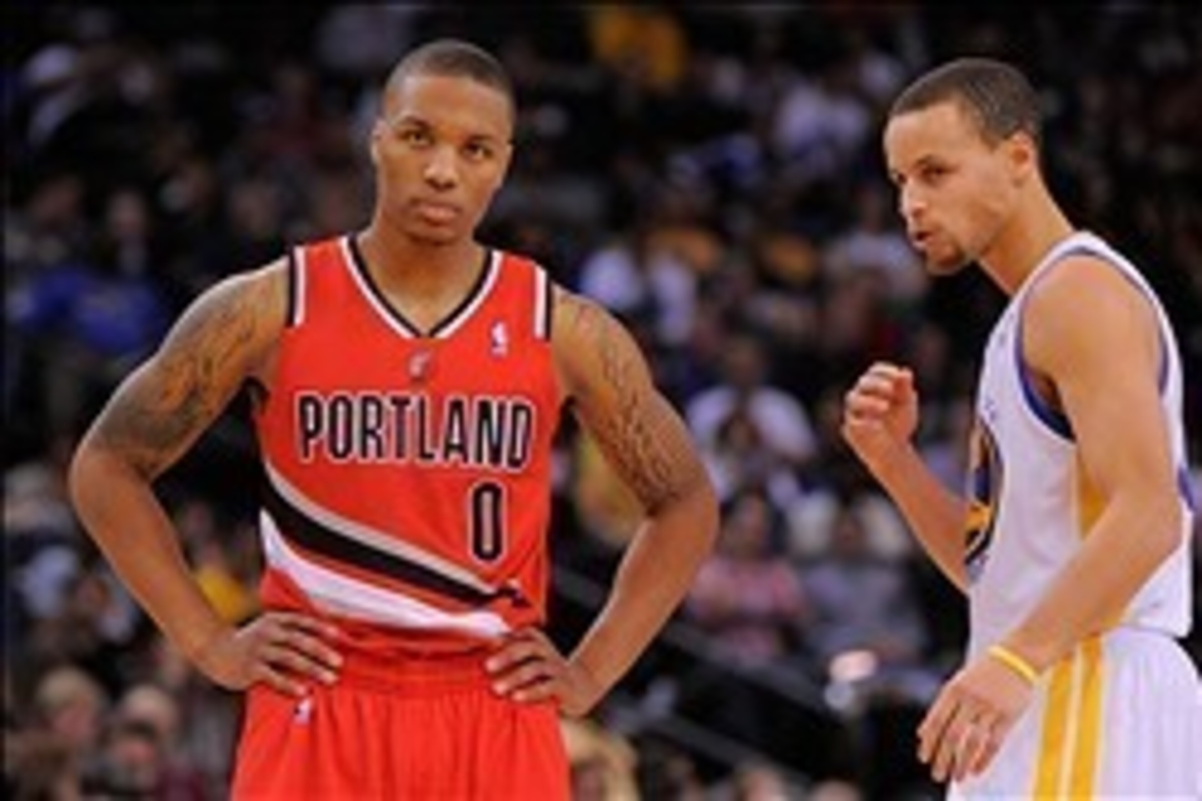 January 11, 2013; Oakland, CA, USA; Portland Trail Blazers point guard Damian Lillard (0) and Golden State Warriors point guard Stephen Curry (30, right) look on during the third quarter at Oracle Arena. The Warriors defeated the Trail Blazers 103-97. Man