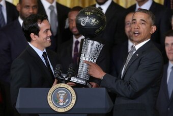 WASHINGTON, DC - JANUARY 14:  National Basketball Association 2012-2013 champion Miami Heat Head Coach Erik Spoelstra (L) presents a commemorative trophy to President Barack Obama during an event at the White House January 14, 2014 in Washington, DC. This