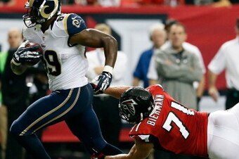 ATLANTA, GA - SEPTEMBER 15:  Jared Cook #89 of the St. Louis Rams tries to break a tackle by Kroy Biermann #71 of the Atlanta Falcons at Georgia Dome on September 15, 2013 in Atlanta, Georgia.  (Photo by Kevin C. Cox/Getty Images)