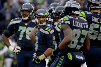 SEATTLE, WA - JANUARY 11:  Quarterback Russell Wilson #3 of the Seattle Seahawks looks on in the third quarter while taking on the New Orleans Saints during the NFC Divisional Playoff Game at CenturyLink Field on January 11, 2014 in Seattle, Washington.  