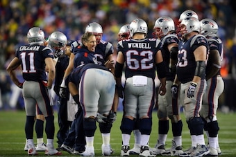 FOXBORO, MA - JANUARY 11:  Head coach Bill Belichick of the New England Patriots talks with his team during a break in play in the AFC Divisional Playoff game against the Indianapolis Colts at Gillette Stadium on January 11, 2014 in Foxboro, Massachusetts